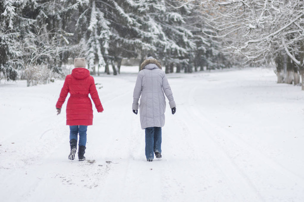 Dnepr, Ukrajna - December 03, 2016:Two nők gyaloglás-ra egy üres, havas utca Dnepr, Ukrajna-2016. December, 03: - Fotó, kép