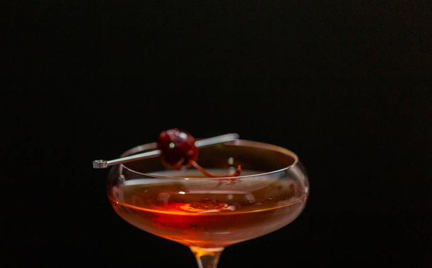 Manhattan cocktail garnished with brandied cherry. - Photo, Image