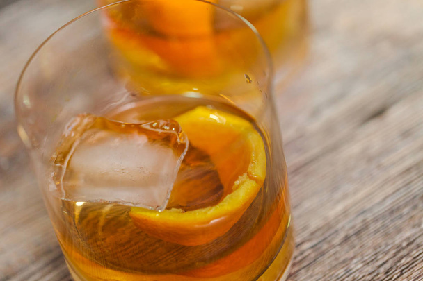 Bourbon old fashioned cocktail garnished with orange peel. - Photo, image
