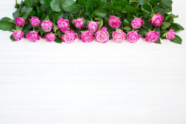 Красиві рожеві троянди на білому дерев'яному фоні
 - Фото, зображення
