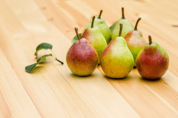 pears on wood table closeup with leaves - Φωτογραφία, εικόνα