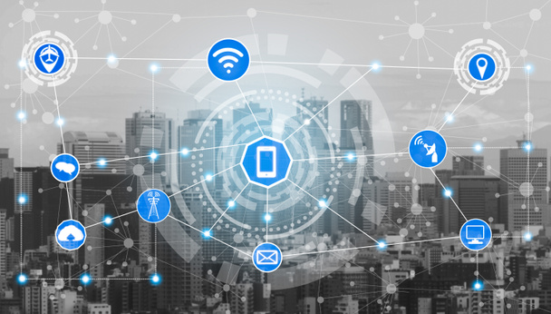 Smart city wireless communication network with graphic showing concept of internet of things ( IOT ) and information communication technology ( ICT ) against modern city buildings in the background. - Photo, Image