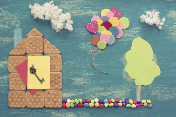 The concept of a cookie house on a wooden blue sky cloud background family path. Top view Flat lay - Photo, Image