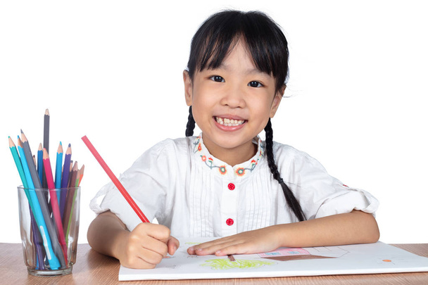 Asian Little Chinese girl painting on paper in isolated white background - Foto, Imagem