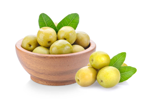 green olives in wood bowl on a white background - Photo, Image