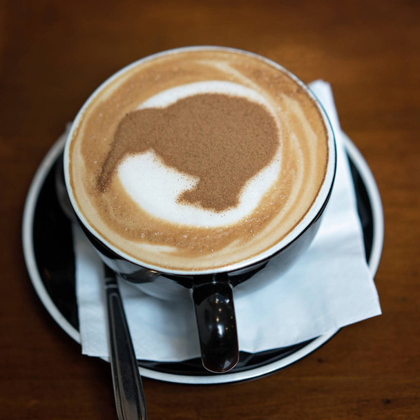 A cup of cappuccino coffee with a kiwi in chocolate sprinkles, New Zealand - Photo, Image
