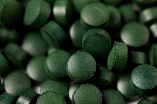 full frame image of pile of spirulina pills background  - Foto, afbeelding