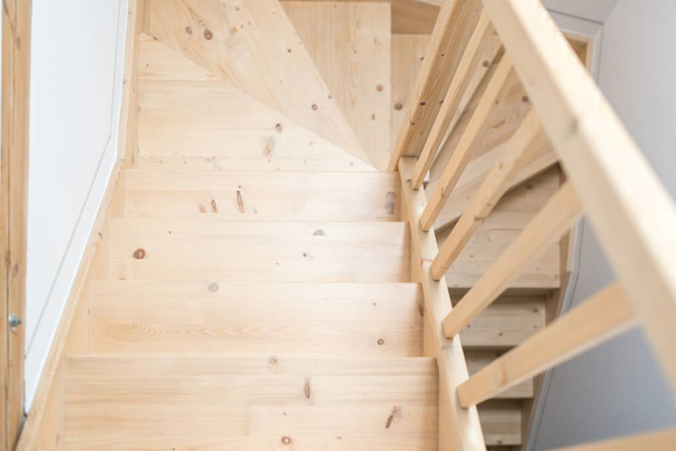 Wooden pine stairs in hall. Modern, bright attic apartment. - Valokuva, kuva