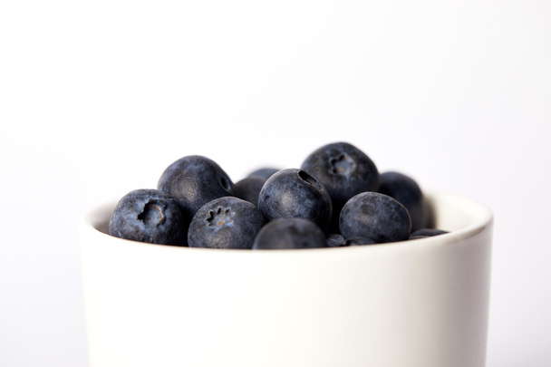 selective focus of blueberries in bowl isolated on white background  - Foto, Bild