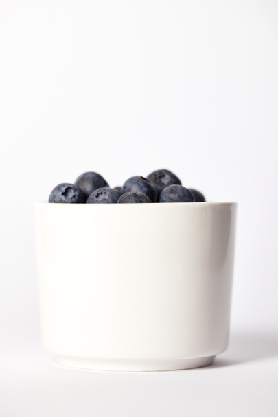 close up view of bowl with blueberries on grey background  - Фото, зображення