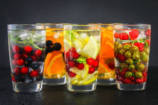 Various detox water in glasses, different tastes, berries, fruits - Photo, image