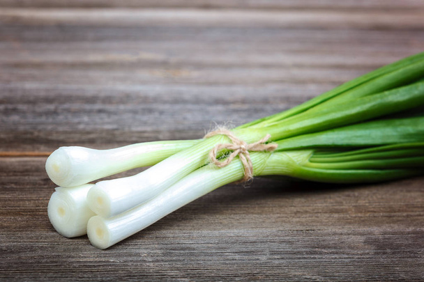 Onion green fresh on a wooden background. - Foto, immagini