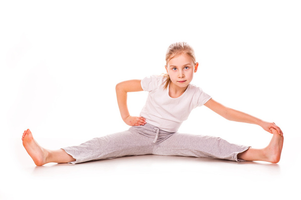 Beautiful girl gymnast exercising, stretching - Photo, Image