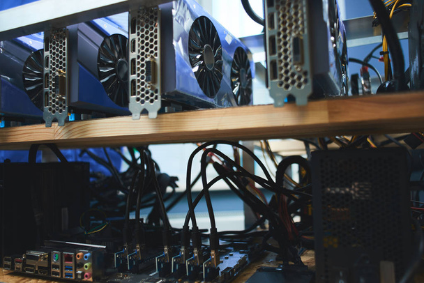 wooden shelves with farm graphics cards for mining crypto currencies - Fotó, kép