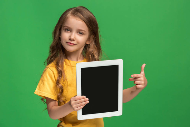 Little funny girl with tablet on green background - Fotografie, Obrázek