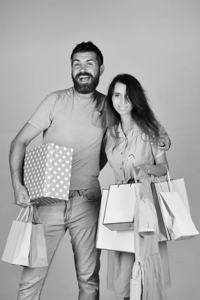 Shopping and leisure concept. Man with beard holds polka dotted box. Couple in love - Foto, Imagem