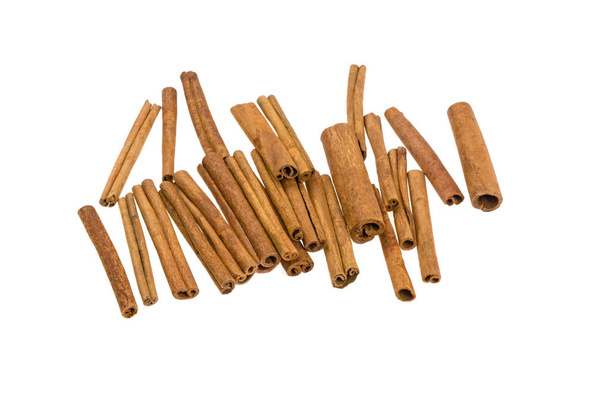 a lot of cinnamon sticks on a white background - Photo, Image