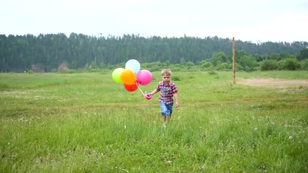 Happy little baby, fun running around with balloons. Outdoor recreation. Celebration and fun.Childs birthday - Footage, Video