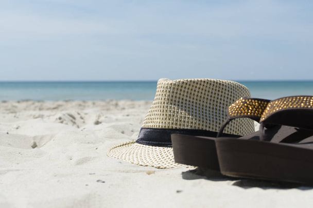 Vacation concept. Essentials on the sea beach. , hat, flip-flops. - Photo, Image