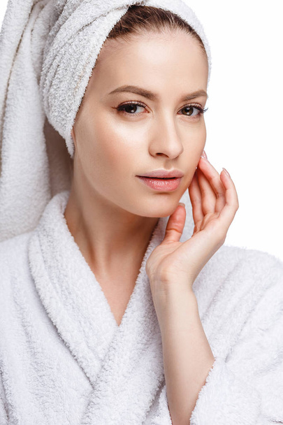 Young woman in a bathrobe and towel on her head, spa and care portrait, clean natural face, portrait on a white background isolated - Fotoğraf, Görsel