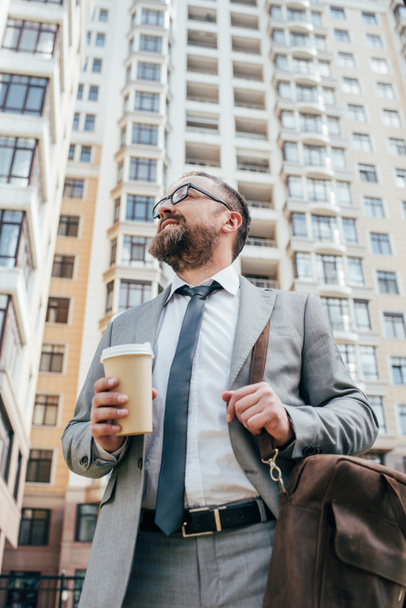 bottom view of businessman in suit with leather bag holding coffee to go - Photo, Image