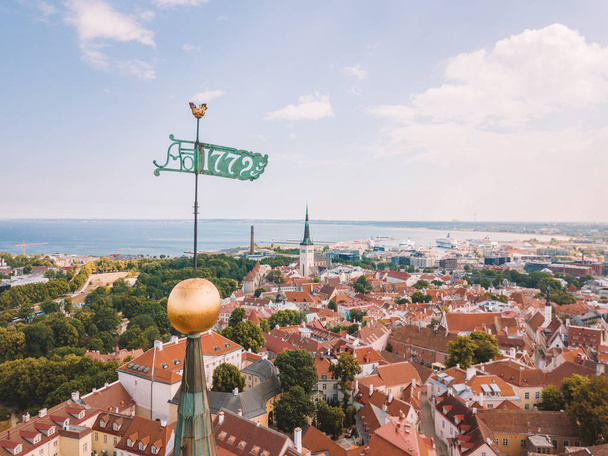 Amazing aerial view of the Tallinn old town with many old houses sea and castle on the horizon. - Fotó, kép