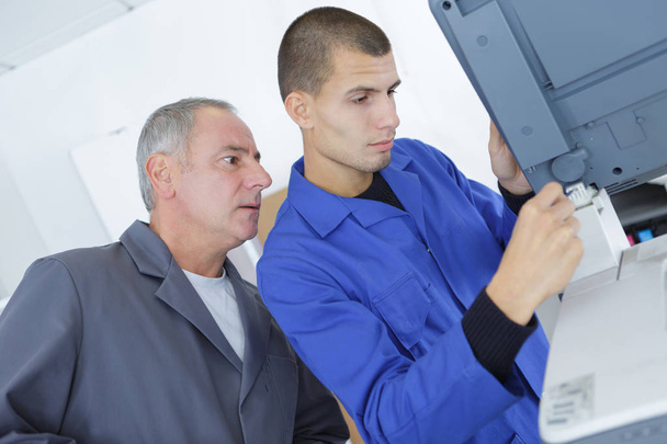 technician and apprentice stand in industry - Photo, image