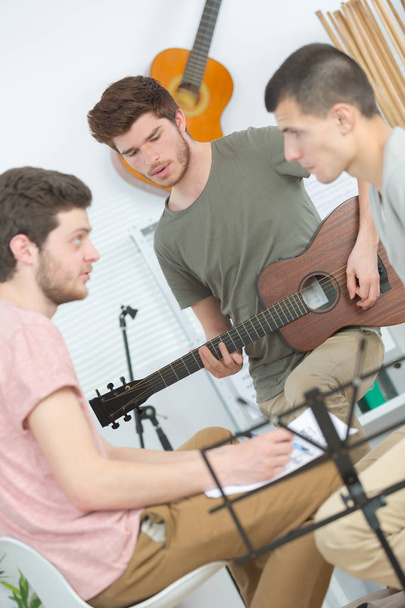 three friends making music at home - Foto, Bild