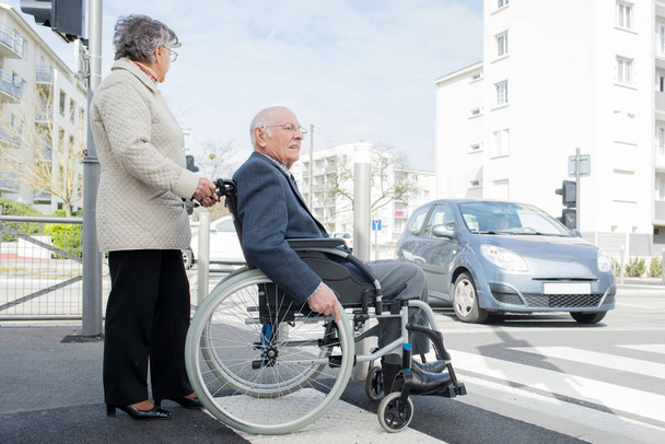 wealthy senior man in wheelchair with wife retirement - Fotoğraf, Görsel