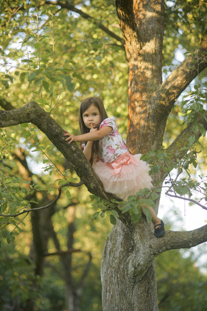Girl with finger show hush silence sign, gesture on tree - Φωτογραφία, εικόνα