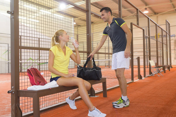 sportsman and sportswoman resting after tennis training - Photo, Image