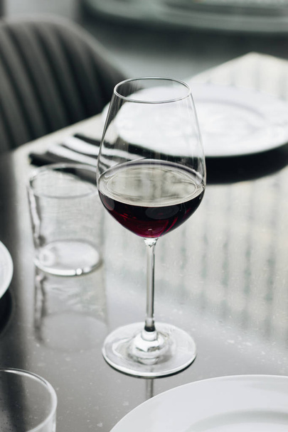 wineglass with red wine on table in restaurant  - Photo, Image