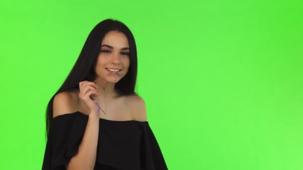 Gorgeous elegant woman in black dress posing seductively at studio - Footage, Video