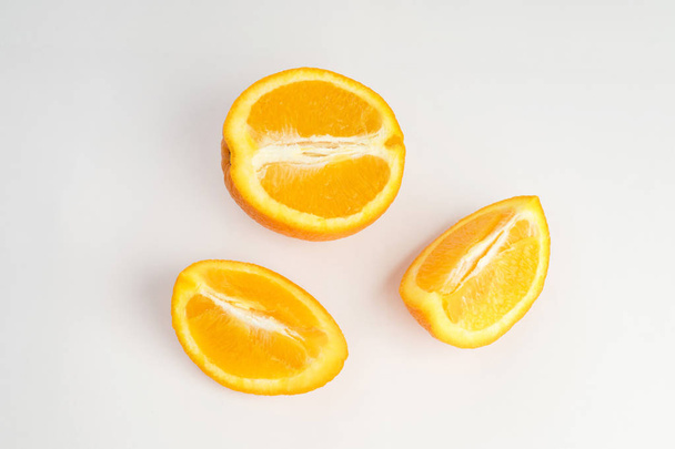 cut fresh orange fruit on white background - Foto, imagen