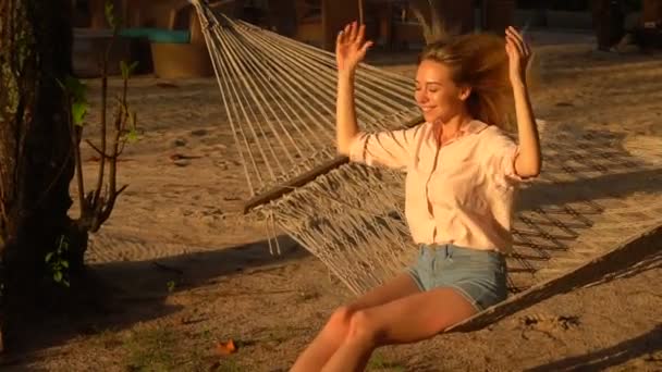Slow motion lawyer girl sitting on hammock enjoying sun. - Footage, Video