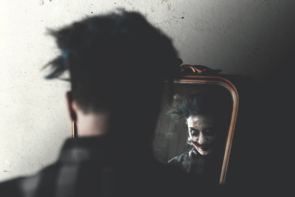creepy clown smiling in front of mirror - Photo, Image