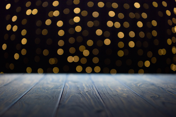 empty wooden planks surface and shiny golden bokeh background - Photo, Image