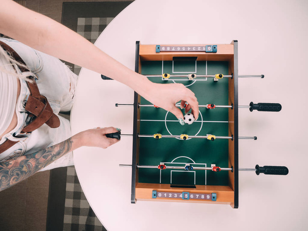 Mini table football foosball soccer with girl hands. - Foto, imagen