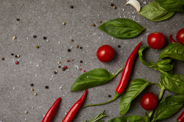 top view of tasty tomatoes, garlic and chili peppers on grey table - Photo, Image