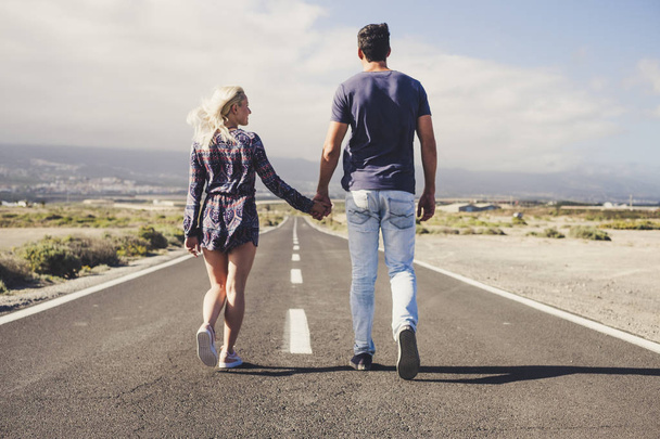 couple of lover in friendship and relationship walk together forever on a long infinite road. travel and life in family concept. team winner and outdoor lifestyle - Photo, Image