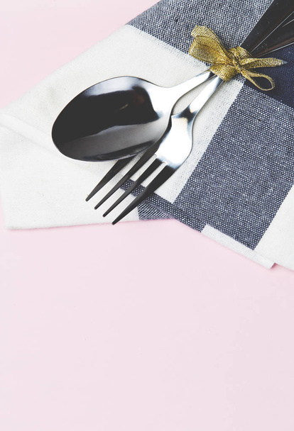 Set table with silver spoon and white napkin on pink background - Photo, Image