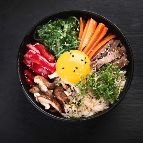 Bibimbap - traditional Korean dish with rice, vegetables, beef  - 写真・画像