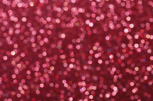 Red glittering christmas lights. Blurred abstract background. - Foto, afbeelding