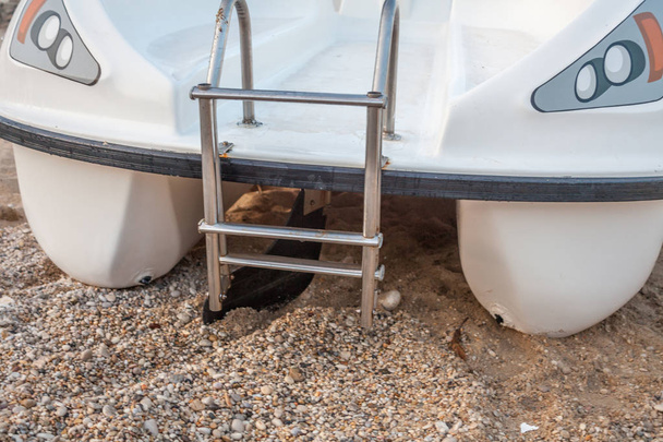 A speed boat in the  course sand. A water vehicle stairs for getting up. An aluminum brass mounted at the back. Mode of transportation during island hopping - Photo, Image