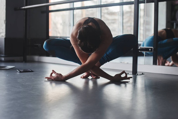 woman practicing yoga pose in gym  - Фото, изображение