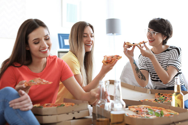 Young people having fun party with delicious pizza indoors - Photo, image