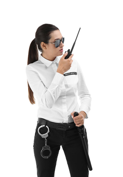 Female security guard using portable radio transmitter on white background - Foto, Imagen