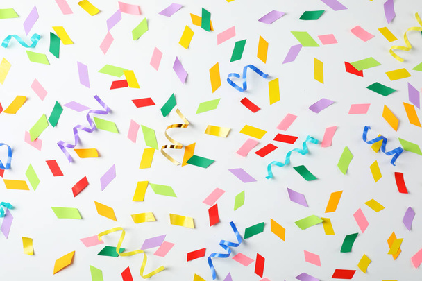 Colorful confetti and streamers on white background, top view - Foto, immagini