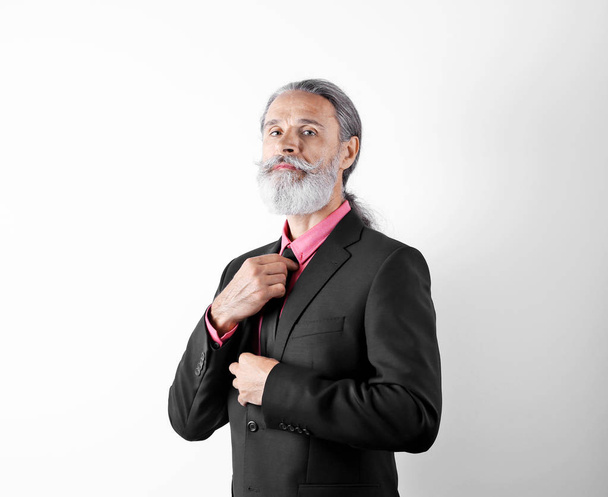 Handsome bearded mature man in suit on white background - Foto, afbeelding