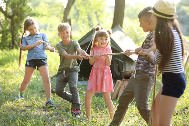Little children pulling rope outdoors. Summer camp - Photo, Image